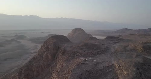 Flying over rocky desert mountains