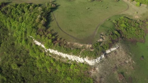 Aerial view of limestone cliffs and green forest in the spring. Geological formation in Transylvani
