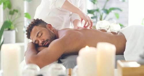 Man Receiving Cupping Therapy in Relaxing Setting