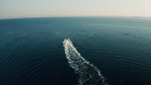 Small Motor Boat Quickly Navigates on Azure Sea Water to Horizon