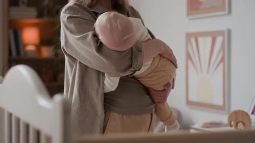 Mother Holding Her Baby in Interior Home Setting