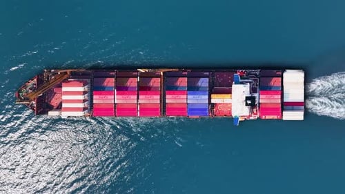 Container ship navigates busy trade routes through ocean waters