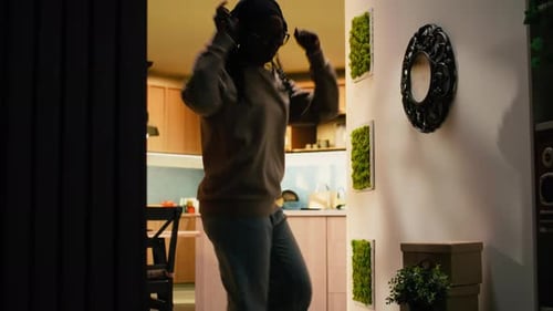 Woman Dancing to Music in Hallway at Home