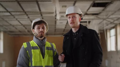 Building Inspector Talking to Construction Worker Architect Engineers in Hardhats Discussing