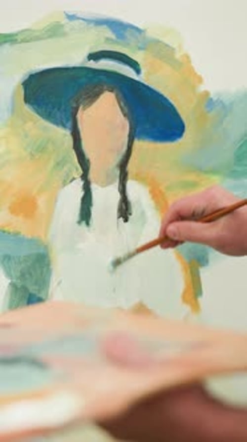 Artist Painting a Portrait on Canvas