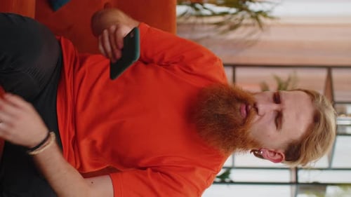 Man Upset Using a Mobile Phone Indoors