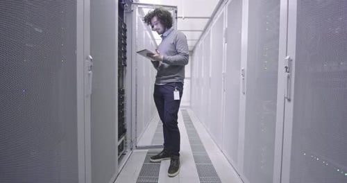 Man Working with Tablet in Data Center Server Room