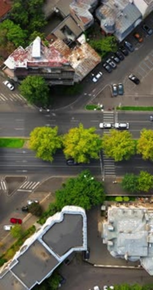 Aerial drone view of cars moving in traffic through the city. Vertical, Bucharest, Romania