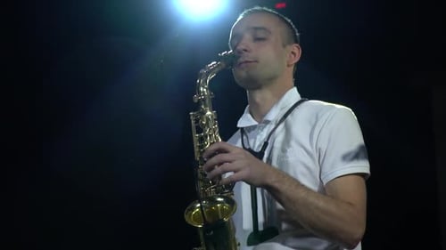 Very bright lights on the background of a saxophone player