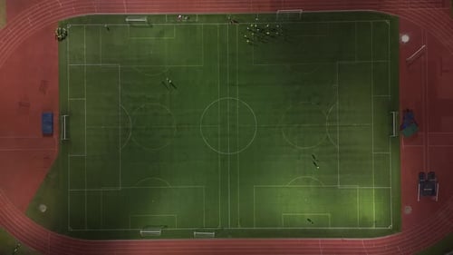 Aerial View of Soccer Field at Night with Players