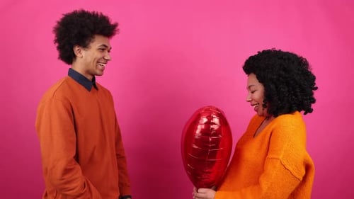 Couple Holding Heart Balloon Celebrating Valentine's Day