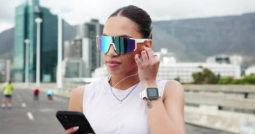 Runner, earphones and woman in city for exercise, cardio workout and training for marathon