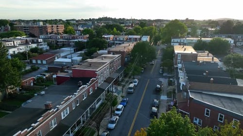 USA downtown city aerial establishing shot of residential rowhomes in downtown area. Summer magic ho