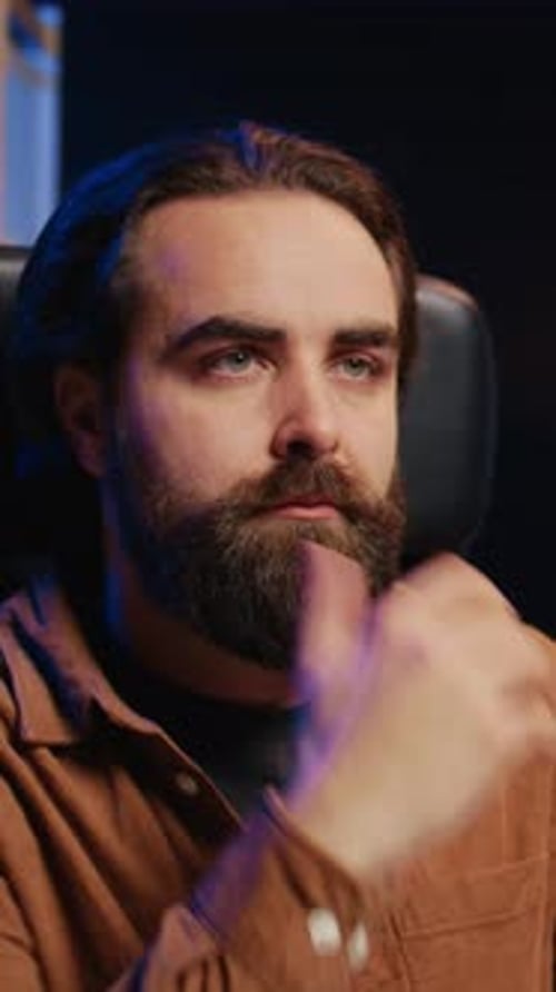 Pensive Man Drinking Coffee While Thinking Indoors at Night
