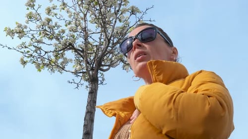 Woman Using an Inhaler Outside on Sunny Day
