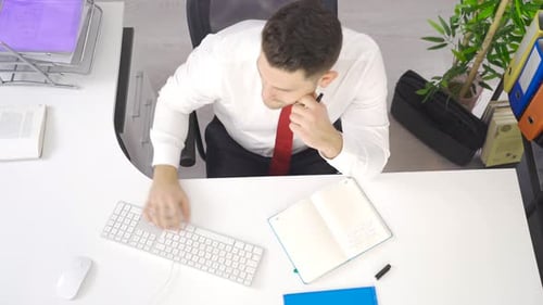 Thoughtful businessman working in the office.