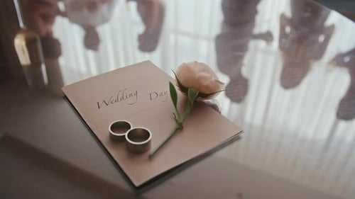 Wedding Rings and Rose on Invitation, Close Up