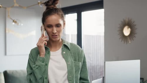 Woman Talking on Cell Phone at Home