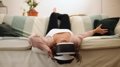Woman Using Virtual Reality Headset on Couch