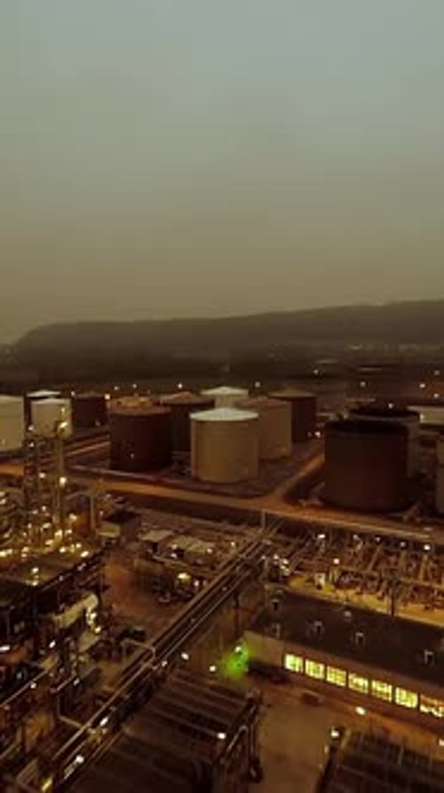 A Comprehensive Aerial View of Industrial Storage Tanks Situated in a Smoky Environment