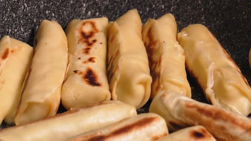 Homemade cheese rolls or pancakes with filling, pan-fried.