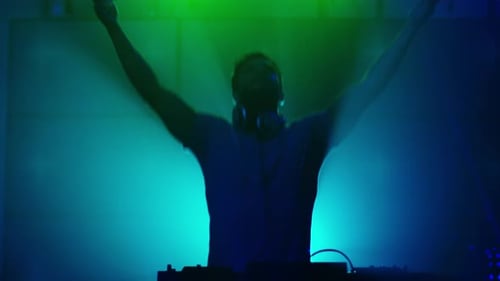 Backlit DJ Playing Music in Nightclub. Silhouette of a DJ. Bright Animation on Background.