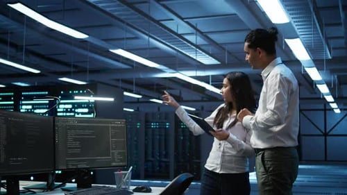 Employee Using Green Screen Devices in Server Farm Used for Automation