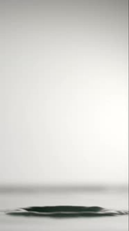 Water Drop Impacting Smooth Surface in Macro Shot