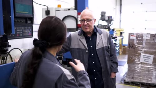 Arbeiter sprechen 10 Sekunden oder länger an Maschinen in der Produktionsstätte