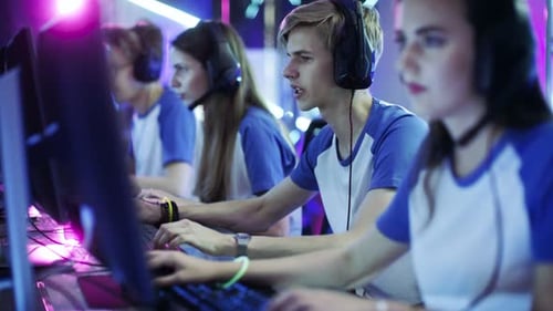 Team of Professional eSport Gamers Playing in Competitive Video Games on a Cyber Games Tournament.