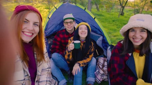 A Lively Group of Friends Taking a Selfie of Camping Trip Outdoors Sharing Smiles and Laughter While