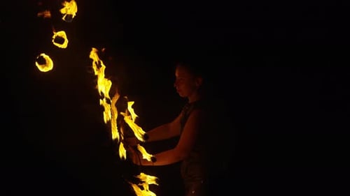 Two Women Performing Skilled Fire Spinning at Night