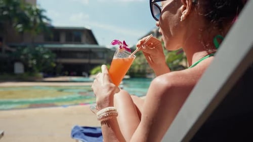 Young Woman Relaxed Near Swimming Pool Beautiful Girl in Bikini Enjoy Drinking Fresh Cocktail Having