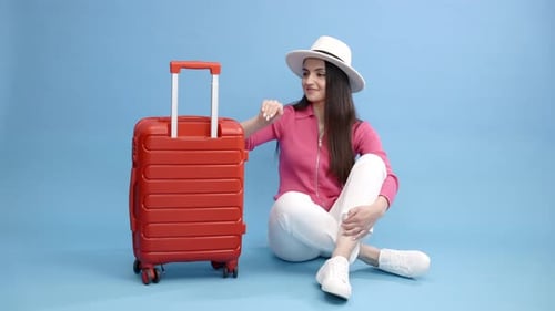 Brunette Woman Gives Thumbs Up With Travel Suitcase