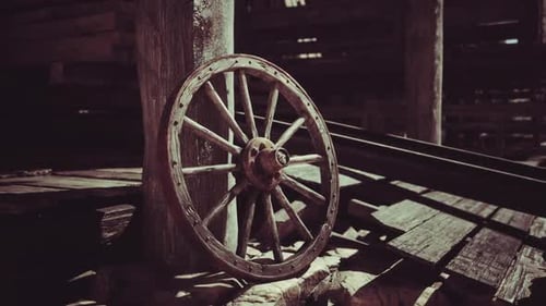 Rustic Old Wooden Cartwheel Leaning Against Post
