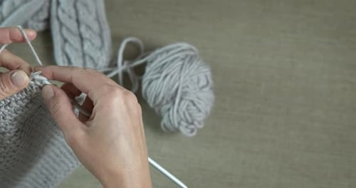 Hands Knitting With Gray Yarn Close-Up