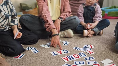 Inspired Young Educator Teaching Spelling to Children in Kindergarten Classroom