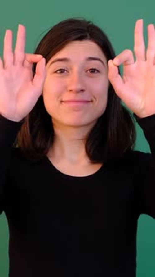 Young Woman Gives OK Hand Gestures