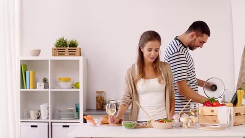 Happy Couple Cooking Healthy Meal Together in Kitchen