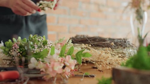 Close View of Flowers Greenery and Dried Stems on Wooden Table