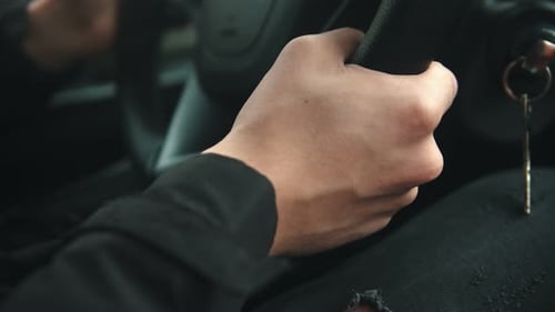 Young Man Driving a Car Holding Steering Wheel