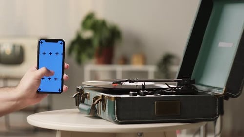 Vinyl Record with Phone and Blue Chroma Key Closeup