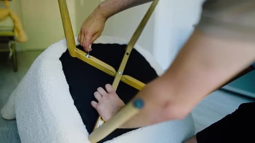 Close-up of Hands Assembling a Chair with Instrument. Assemble Furniture according to Instructions