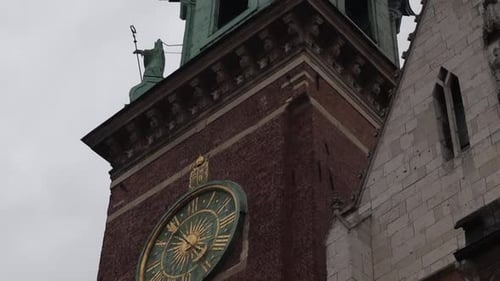 Old, historic tower with a clock on Wawel Royal Castle in Krakow, Poland.