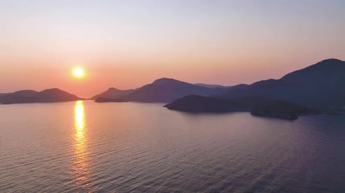 Golden Sunlight Reflecting Off Tranquil Ocean Surface Casting Warm Hues Across Serene Horizon with