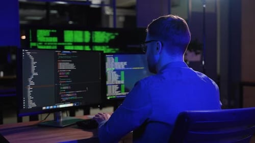 IT Programmer Working on Desktop Computer