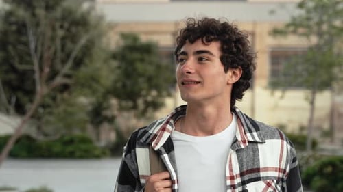 Carefree Teenager Student Walking in the College School Campus Young Inspired Man Smiling to Camera