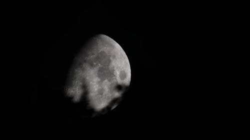 Ethereal Moon Behind Clouds in Night Sky