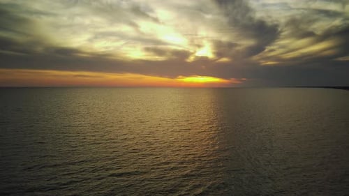 Aerial Shot of Beautiful Sea Against Sky During Sunset Drone Flying Forward Towards Sun