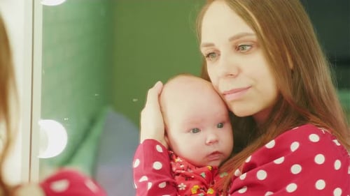 Loving Mother Holding Her Newborn Baby